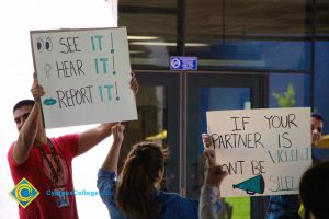 Students holding signs against sexual violence for Sexual Assault Awareness Month.