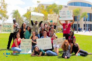 A group of students holding signs against sexual violence.