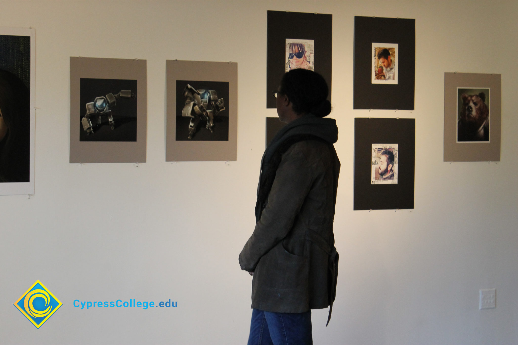 A person looking at artwork on a gallery wall.