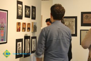 Students looking at artwork on a gallery wall.