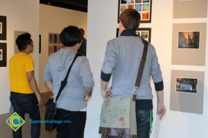 Students looking at artwork on a gallery wall.