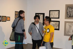 A group of students talking in an art gallery.