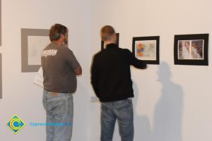 Students looking at artwork on a gallery wall.
