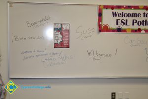 A white board with welcome written in different languages.