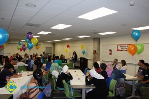 Eldon Young speaking to a room full of guests at the ESL Potluck.