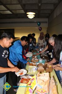 Students serving themselves food at the ESL potluck.