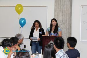 Staff speaking to students at the 2014 ESL potluck.