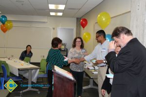 Student receiving award at 2014 ESL Potluck.