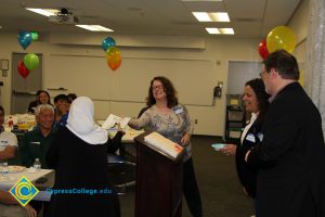 Student receiving award at 2014 ESL Potluck.