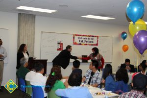 A student shaking hands with a staff member.