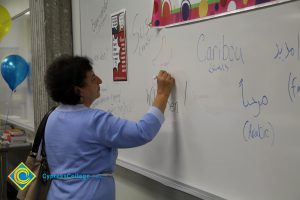 A woman writing on a whiteboard.
