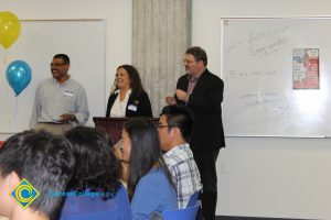 Staff smiling at the ESL potluck.