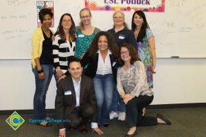Group of people smiling during the 2014 ESL Scholarship Potluck.