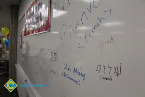 A white board with welcome written in different languages.