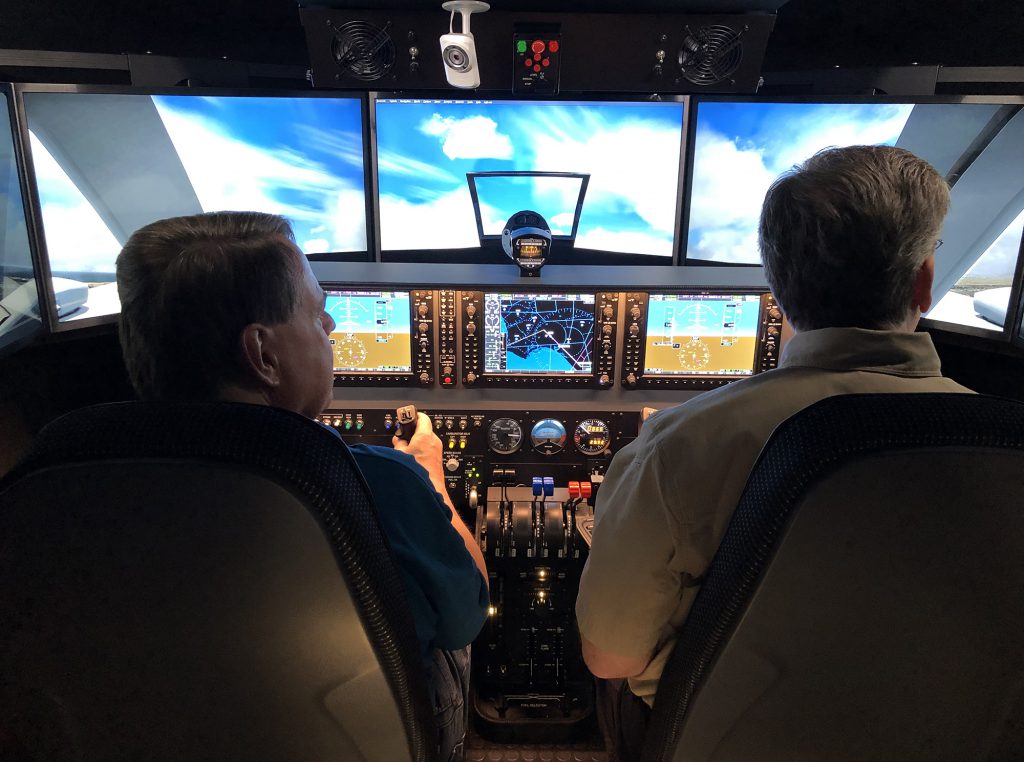 Aviation professors using flight simulator