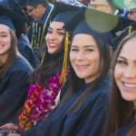 Cypress College graduates seated and focused on the commencement ceremony,