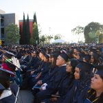 Cypress College graduates seated and focused on the commencement ceremony,