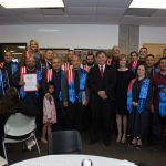 Dr. Schilling standing with a group of Veteran graduates.