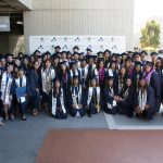 A large group of EOPS students in graduation caps and gowns.