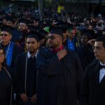 Graduation students dressed in their regalia waiting for commencement to begin.