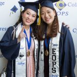 Two female EOPS students in graduation regalia.