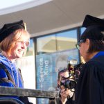 Dr. JoAnna Schilliing congratulating a student graduate.