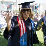 Female Veteran wearing graduation regalia.