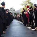 Faculty and staff lined up along the graduate processional path.