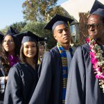 Graduates walking the commencement processional.