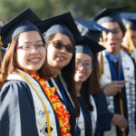 Cypress College graduates smiling during commencement ceremony,