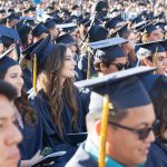 Cypress College graduates seated and focused on the commencement ceremony,