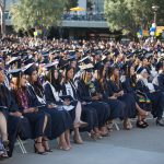 Cypress College graduates seated and focused on the commencement ceremony,