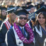 Cypress College graduates seated and focused on the commencement ceremony,