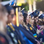 Cypress College graduates seated and focused on the commencement ceremony,