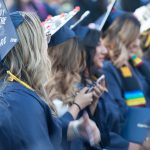 Cypress College graduates seated and focused on the commencement ceremony,