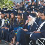 Cypress College graduates seated and focused on the commencement ceremony,