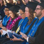 Cypress College graduates seated and focused on the commencement ceremony,