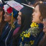 Cypress College graduates seated and focused on the commencement ceremony,