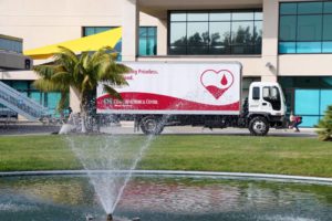 Cypress College pond with Cedar Sinai, Donate Blood, truck in the background.