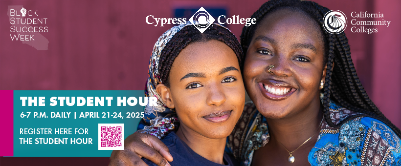 Two black women smile at the camera.