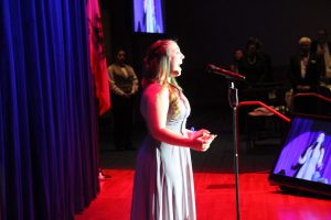 Young woman singing at Americana Awards