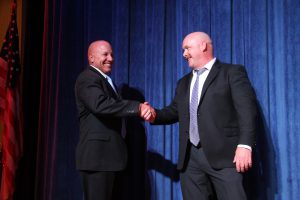 Two men in suits shaking hands