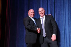 Two men in suits shaking hands