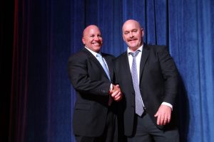 Two men in suits shaking hands