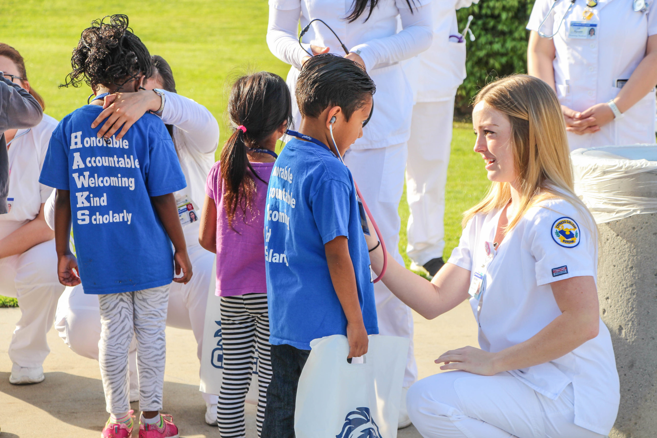 Nursing students checking children's heartbeats