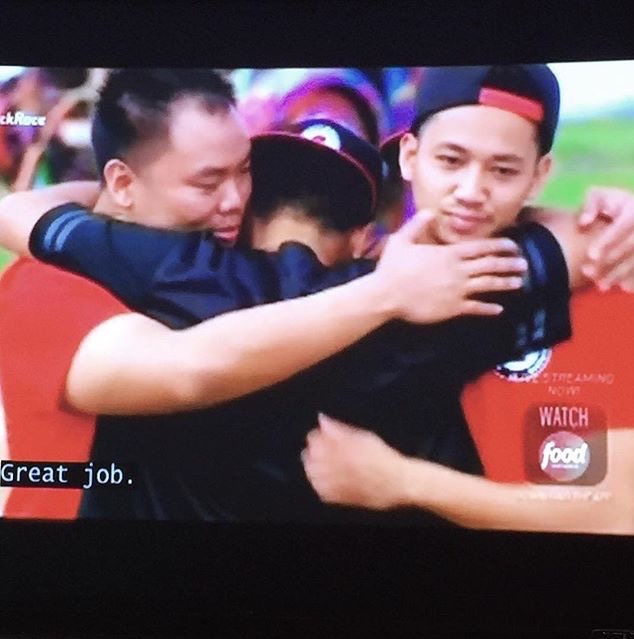 Three men hugging