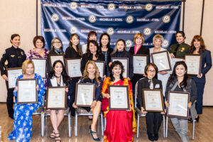 19 women who are recipients of Rep. Michelle Steel's Women of Distinction pose with their certificates and the Congresswoman.