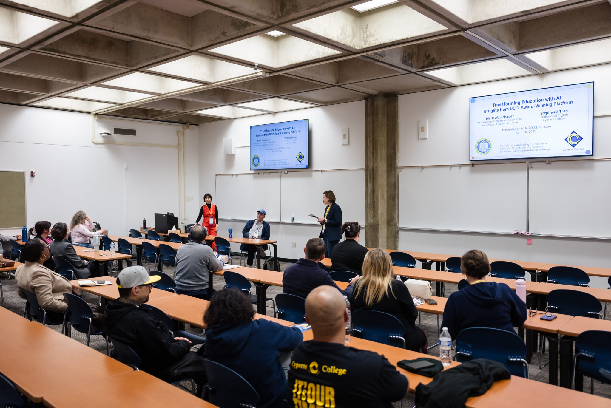 Attendees sit in a classroom and learn from AI experts.