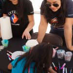 (STEM)² students assisting at Kindercaminata booth