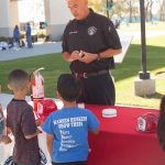 Firefighter speaking to students during Kindercaminata event